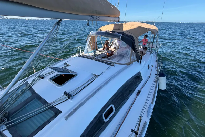 Slide: The Image of 2008 Beneteau Oceanis 40 sailboat cruising on open water with passengers on deck. - 62