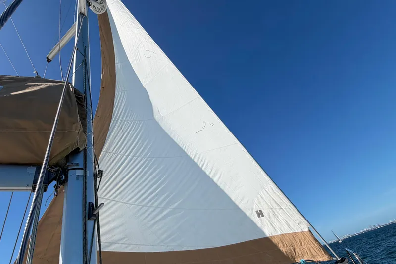 Slide: The Image of Sailing on a 2008 Beneteau Oceanis 40 with white sails against a clear blue sky. - 64
