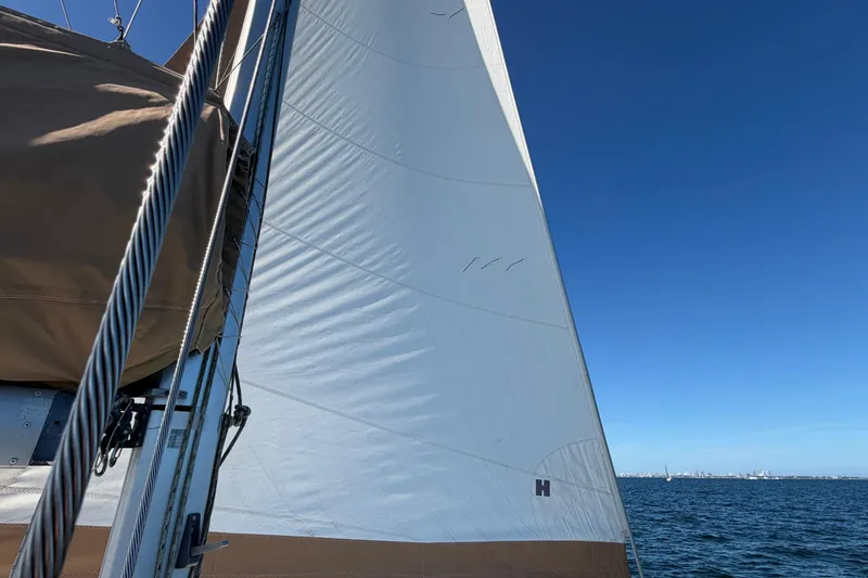 Slide: The Image of Sailing on a 2008 Beneteau Oceanis 40 with white sails against a clear blue sky. - 66