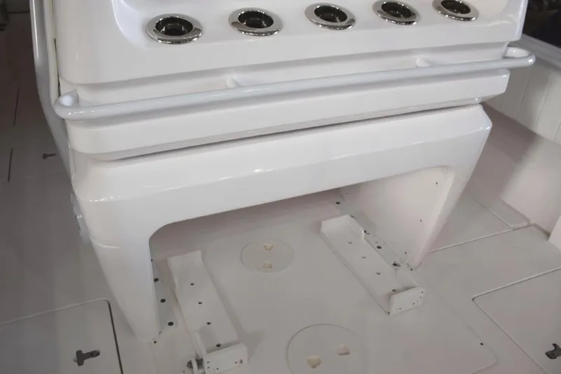 Slide: The Image of Behind helm seat console, drink holder or rod holders and safety grab railing, cooler chocks beneath. - 25