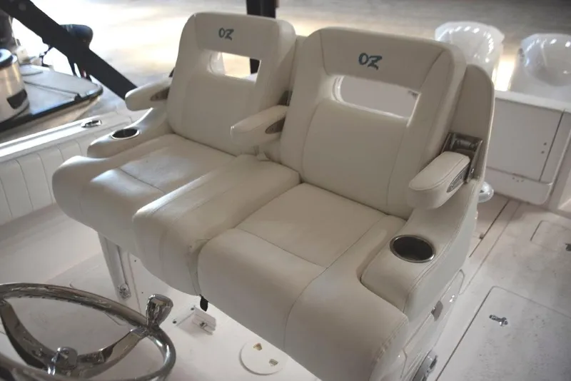Slide: The Image of Ocean Elite helm seat console with fold-down armrests and drink holders. - 5