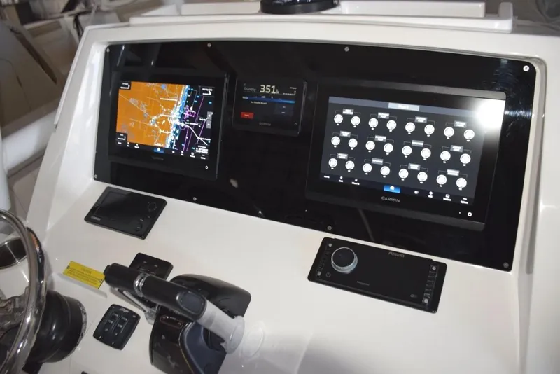 Slide: The Image of Dual Garmin 12-inch displays with Garmin autopilot between. Digital switching for boat systems via Garmin. - 6