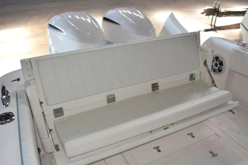 Slide: The Image of Cockpit with rear seat hatch closed and transom door open. Livewell and fish boxes below deck hatches. - 8