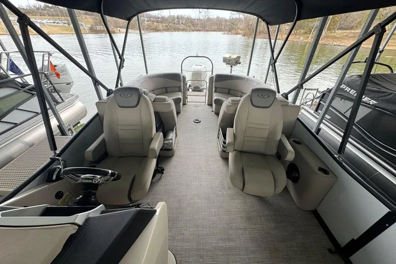 Slide: The Image of 2020 Harris Grand Mariner 250 pontoon boat interior with plush seating and steering console. - 15