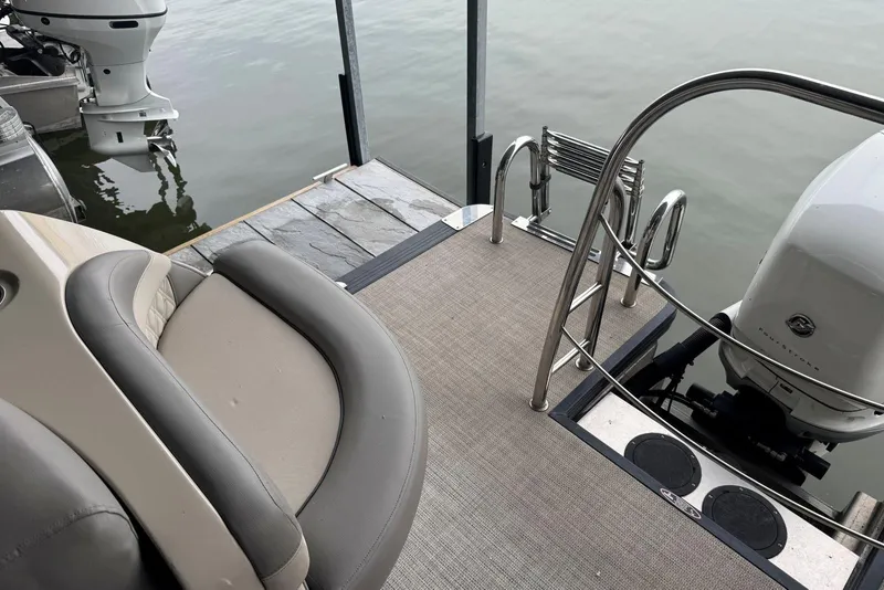 Slide: The Image of 2020 Harris Grand Mariner 250 boat with seating, motor, and swim ladder at dock. - 27