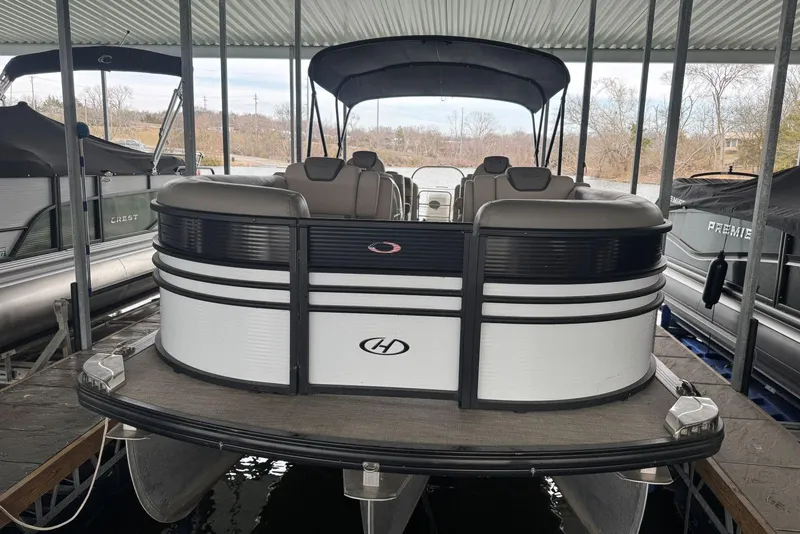 Slide: The Image of 2020 Harris Grand Mariner 250 pontoon boat docked under a covered marina. - 3