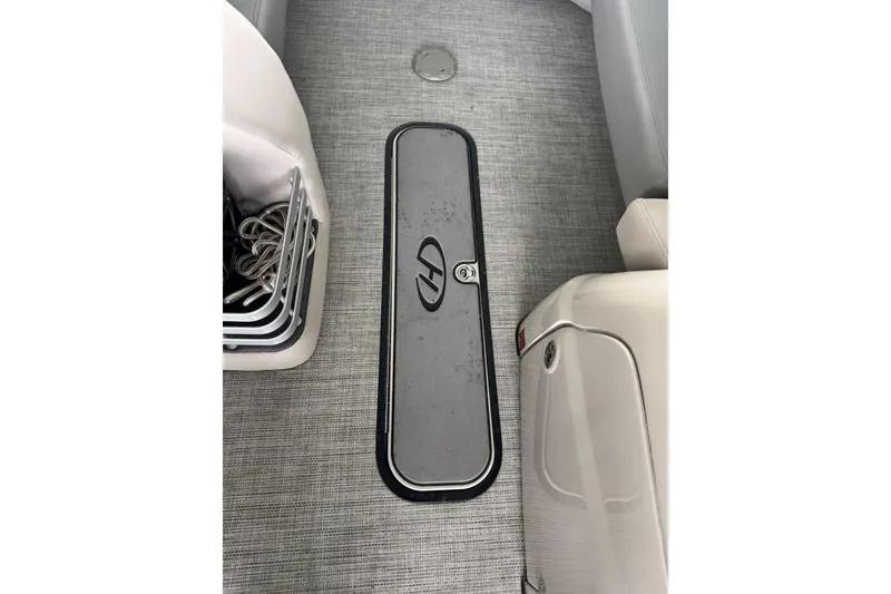 Slide: The Image of 2020 Harris Grand Mariner 250 boat interior with storage compartment and seating. - 34