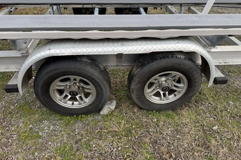 Slide: The Image of Trailer wheels for 2020 Harris Grand Mariner 250 on grassy ground. - 45