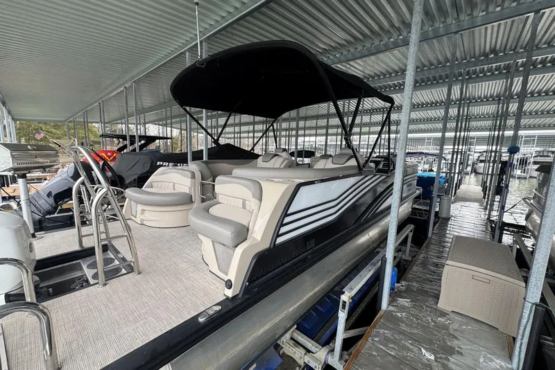 Slide: The Image of 2020 Harris Grand Mariner 250 pontoon boat docked under covered marina. - 7