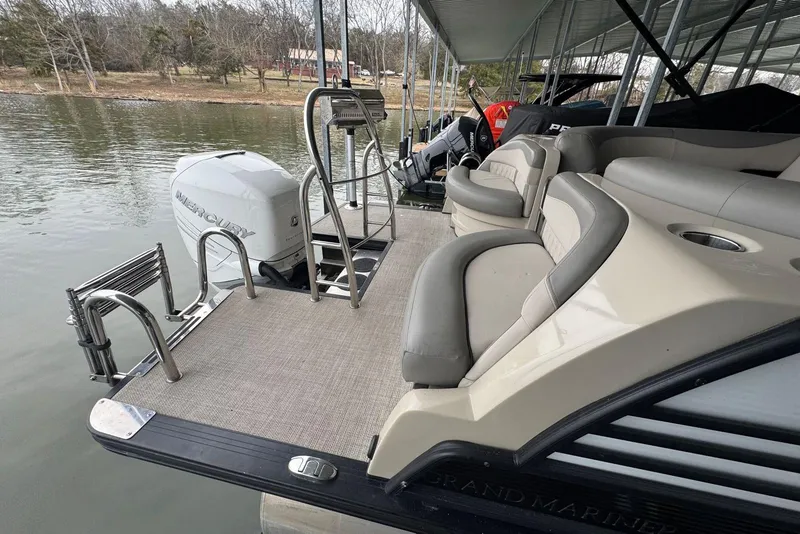 Slide: The Image of 2020 Harris Grand Mariner 250 pontoon boat with Mercury outboard engine, docked on a lake. - 8