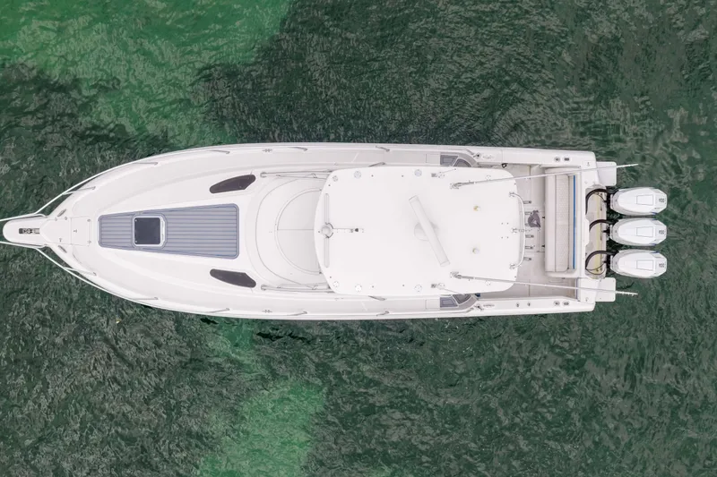 Slide: The Image of Overhead view of 2003 Intrepid 377 Walkaround boat on green water. - 10