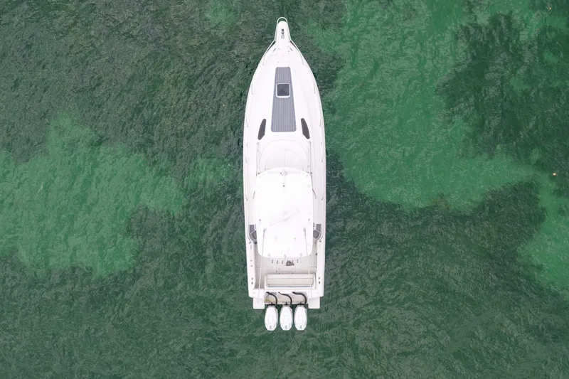 Slide: The Image of Aerial view of 2003 Intrepid 377 Walkaround boat on green water. - 11