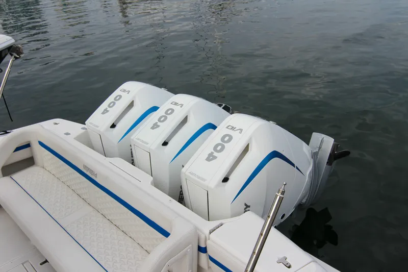 Slide: The Image of 2003 Intrepid 377 Walkaround with triple 400 V8 outboard engines on calm water. - 12