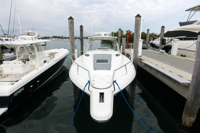 Slide: The Image of 2003 Intrepid 377 Walkaround boat docked at marina, front view. - 14