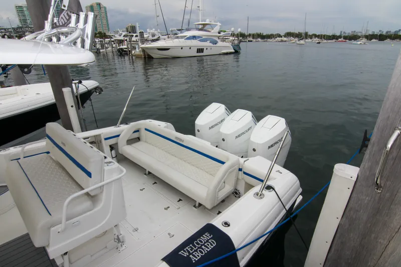 Slide: The Image of 2003 Intrepid 377 Walkaround boat docked with triple Mercury engines. - 17