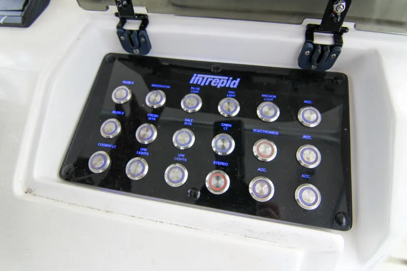 Slide: The Image of Control panel of a 2003 Intrepid 377 Walkaround boat with labeled buttons. - 22