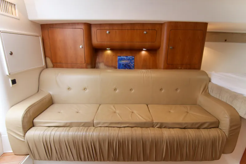 Slide: The Image of 2003 Intrepid 377 Walkaround interior with beige leather sofa and wooden cabinets. - 30
