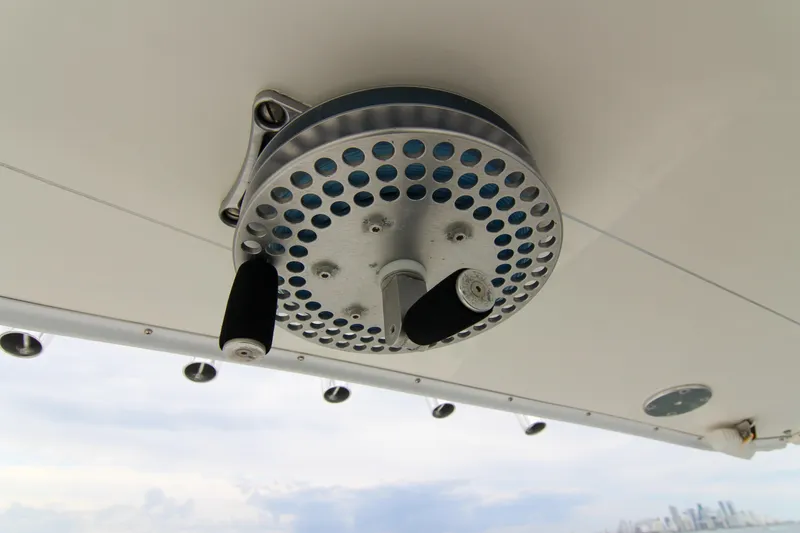Slide: The Image of Ceiling-mounted reel on 2003 Intrepid 377 Walkaround boat, with city skyline in background. - 32