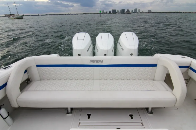 Slide: The Image of 2003 Intrepid 377 Walkaround boat with triple Mercury engines on open water. - 33