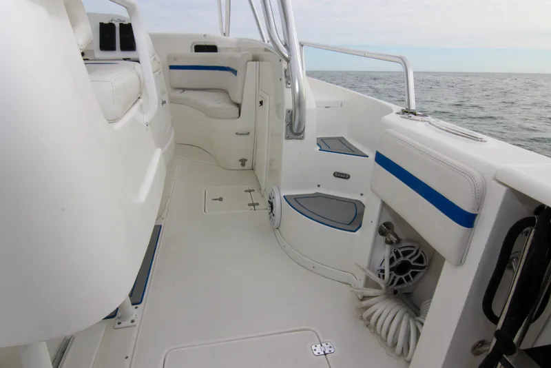 Slide: The Image of 2003 Intrepid 377 Walkaround boat interior with white seating and blue accents. - 37