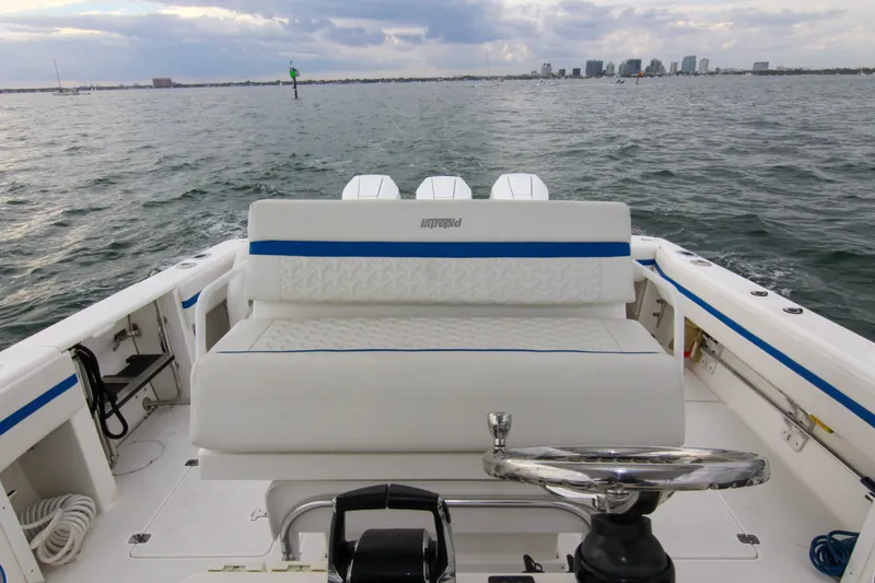 Slide: The Image of 2003 Intrepid 377 Walkaround boat on open water, featuring a spacious seating area. - 39