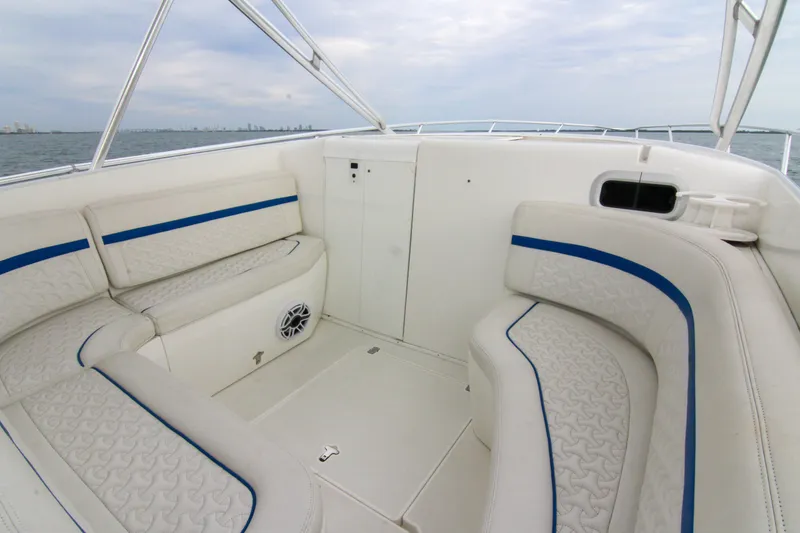 Slide: The Image of 2003 Intrepid 377 Walkaround boat interior with white and blue cushioned seating. - 42
