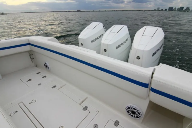 Slide: The Image of 2003 Intrepid 377 Walkaround boat with triple Mercury engines on open water. - 44