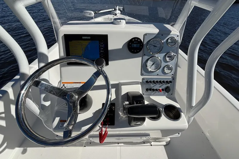 Slide: The Image of 2022 Clearwater 2100 Baystar boat console with steering wheel and navigation instruments. - 12