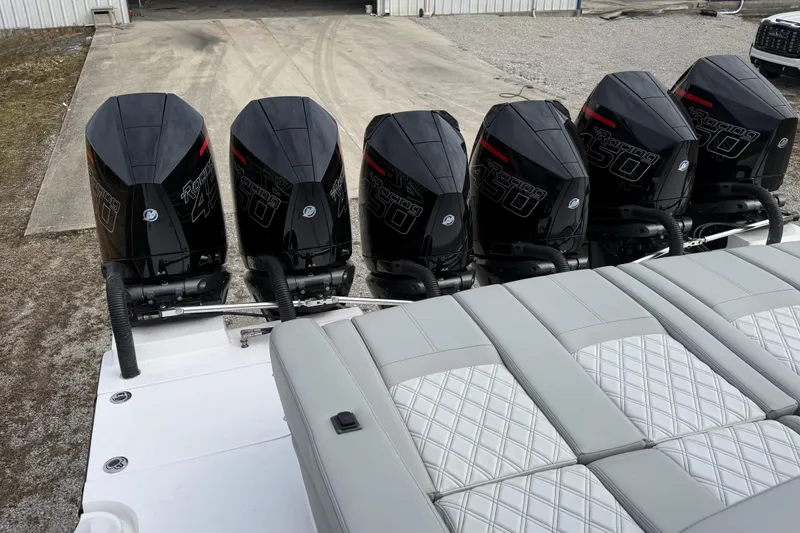 Slide: The Image of 2023 Mystic Powerboats M5200 with six powerful outboard engines, featuring luxurious seating. - 10