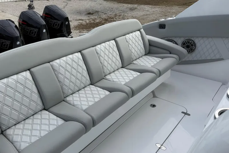 Slide: The Image of Luxurious seating on 2023 Mystic Powerboats M5200 with quilted upholstery and powerful engines. - 12