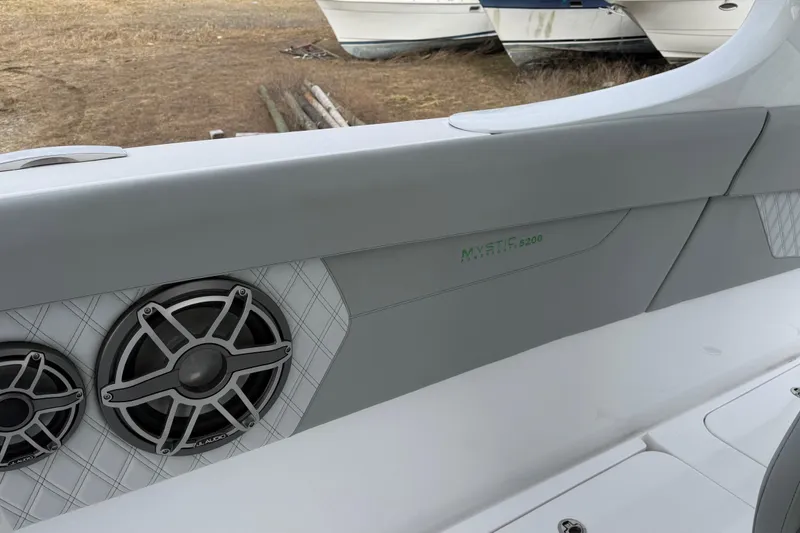 Slide: The Image of 2023 Mystic Powerboats M5200 interior with JL Audio speakers, showcasing luxury design. - 14