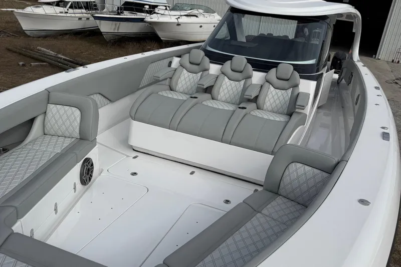 Slide: The Image of 2023 Mystic Powerboats M5200 interior with luxurious seating and modern design. - 18