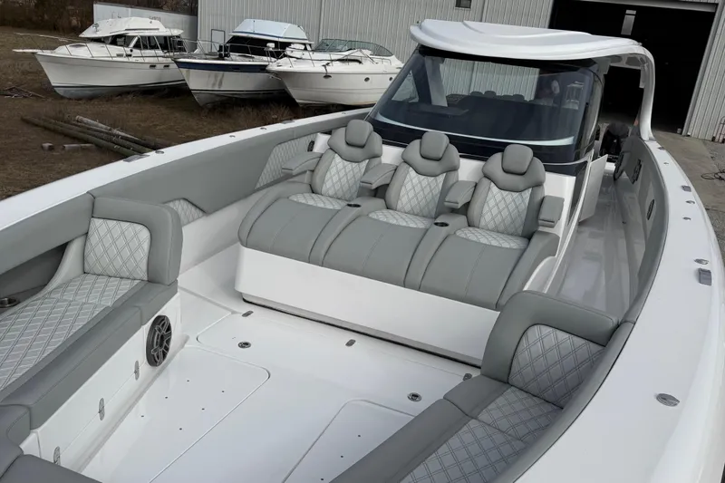 Slide: The Image of 2023 Mystic Powerboats M5200 luxury interior with plush seating and modern design. - 19