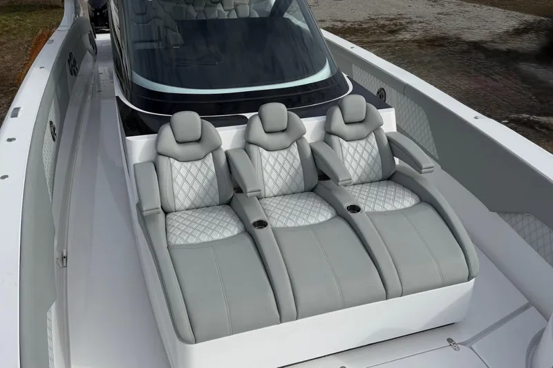 Slide: The Image of Luxurious seating on 2023 Mystic Powerboats M5200, featuring elegant gray upholstery and diamond stitching. - 21
