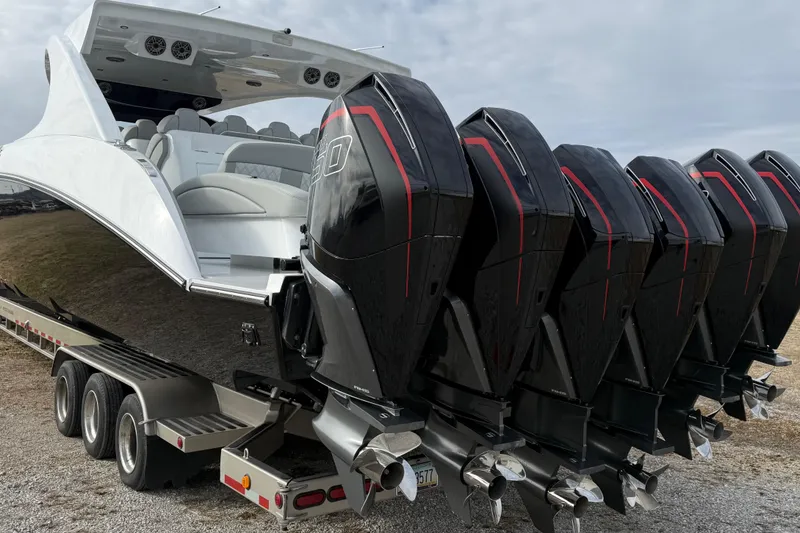 Slide: The Image of 2023 Mystic Powerboats M5200 with multiple powerful outboard engines on a trailer. - 4