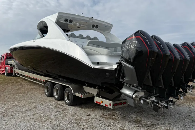 Slide: The Image of 2023 Mystic Powerboats M5200 on trailer with multiple powerful outboard engines. - 5