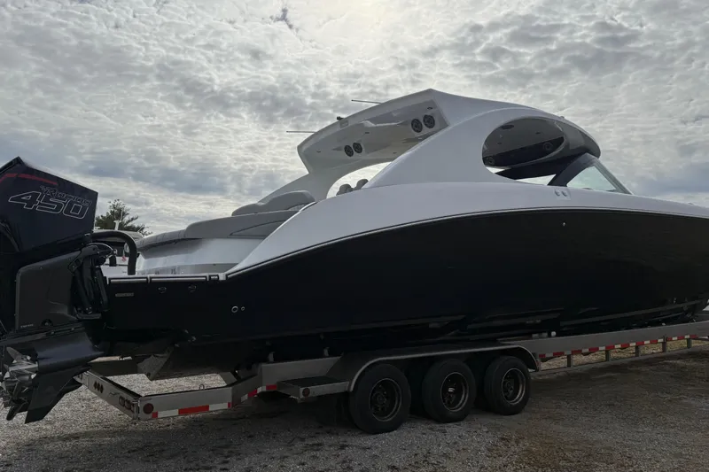 Slide: The Image of 2023 Mystic Powerboats M5200 on trailer under cloudy sky. - 6