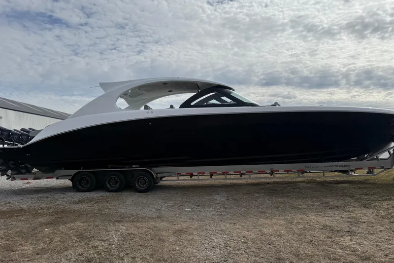 Slide: The Image of 2023 Mystic Powerboats M5200 on trailer under cloudy sky. - 7