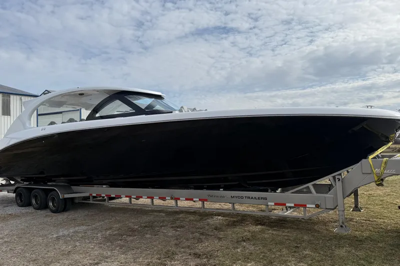 Slide: The Image of 2023 Mystic Powerboats M5200 on trailer under cloudy sky. - 9