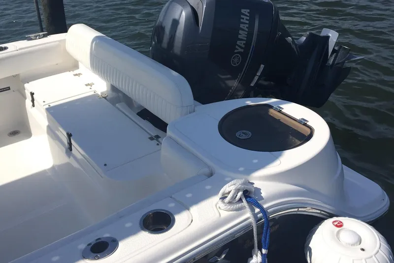 Slide: The Image of 2013 Sea Fox 226 Commander boat interior with Yamaha engine, featuring seating and storage. - 11