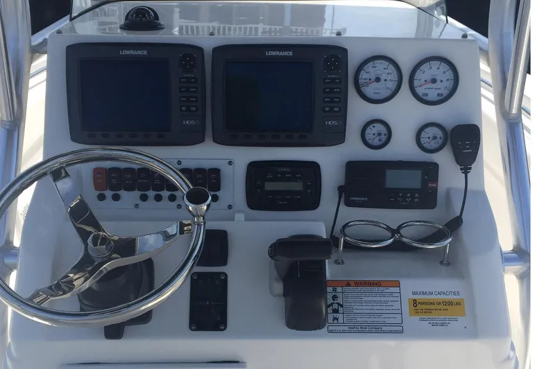 Slide: The Image of 2013 Sea Fox 226 Commander dashboard with steering wheel, gauges, and navigation equipment. - 6