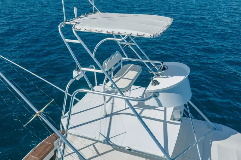 Slide: The Image of 1997 Strike 42 Express boat with elevated helm station on open sea. - 11