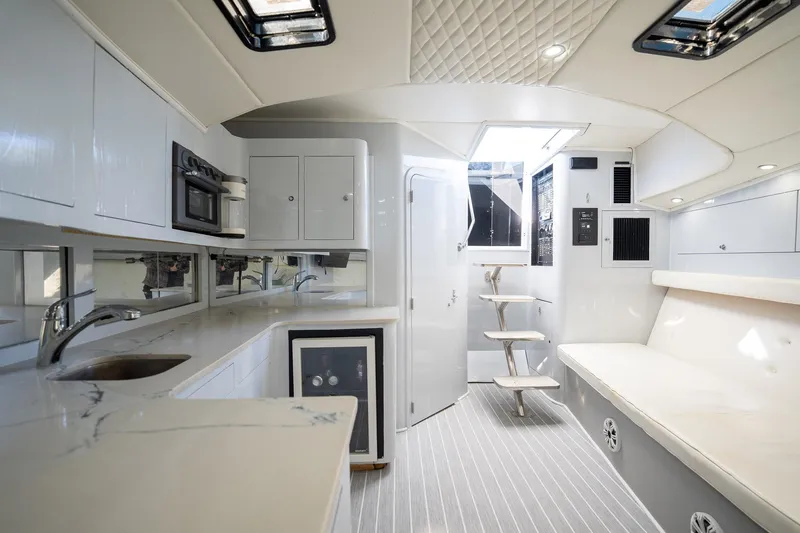 Slide: The Image of Luxurious interior of 1997 Strike 42 Express yacht with modern kitchen and seating area. - 14