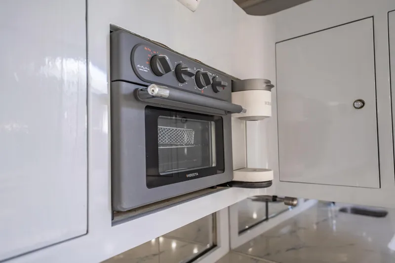 Slide: The Image of Built-in oven and coffee maker in a 1997 Strike 42 Express yacht kitchen. - 21