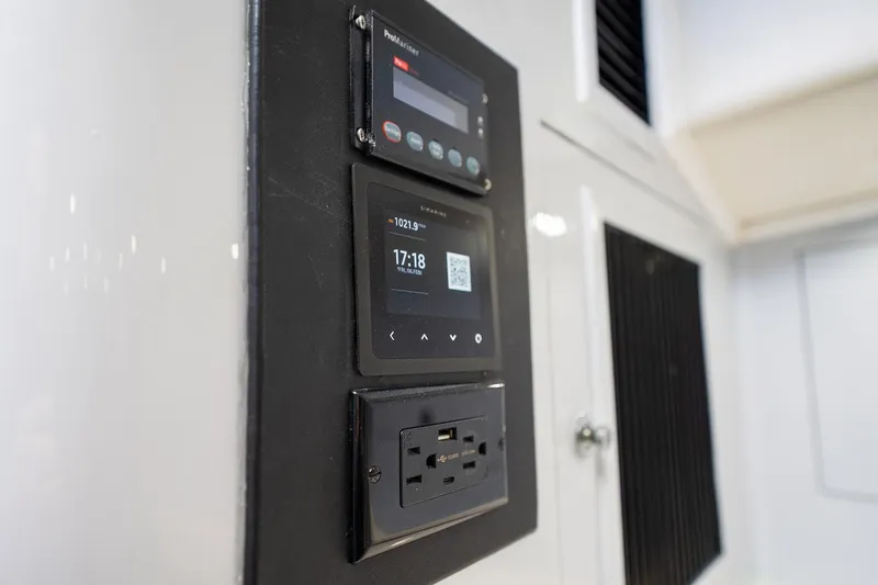 Slide: The Image of Control panel on a 1997 Strike 42 Express boat, featuring digital displays and power outlets. - 23
