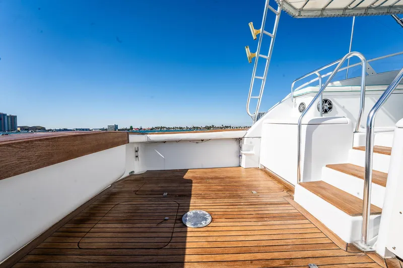 Slide: The Image of Spacious deck of 1997 Strike 42 Express yacht with wooden flooring and metal railings. - 28