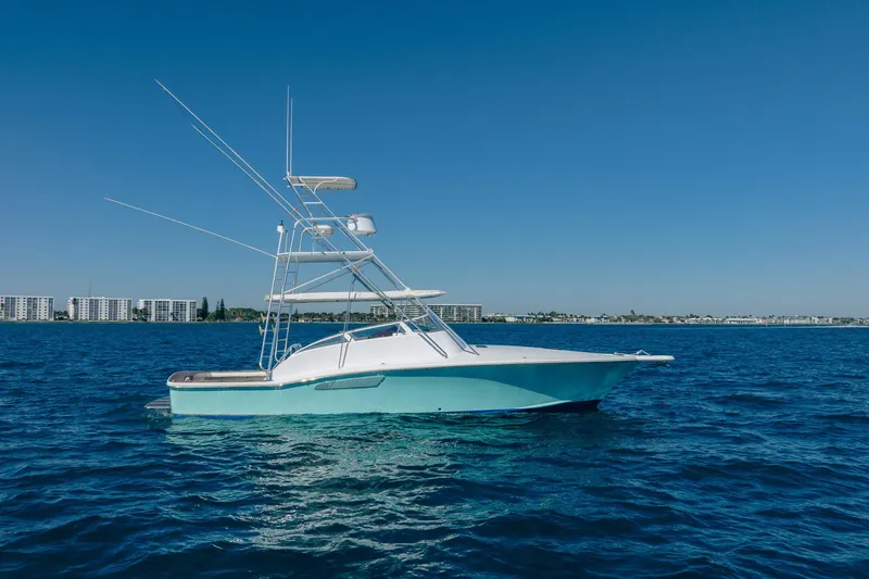 Slide: The Image of 1997 Strike 42 Express boat on calm blue ocean with clear sky background. - 3