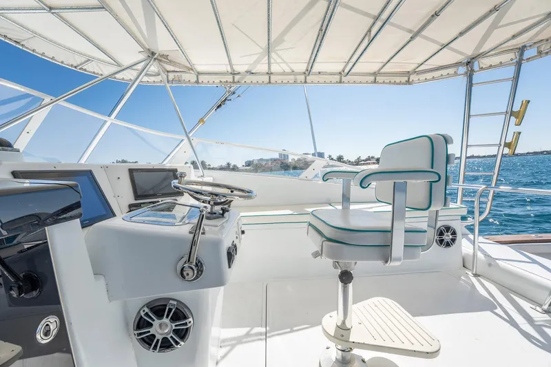 Slide: The Image of Helm of 1997 Strike 42 Express yacht with steering wheel and captain's chair. - 30