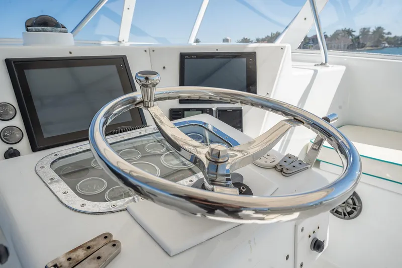 Slide: The Image of Steering wheel and dashboard of a 1997 Strike 42 Express boat. - 32
