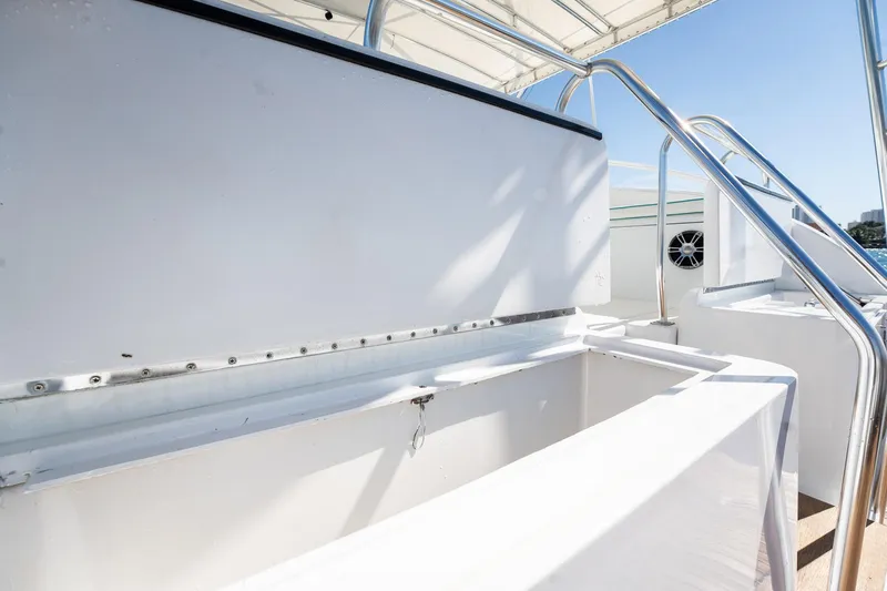 Slide: The Image of 1997 Strike 42 Express boat interior with open storage compartments and stainless steel railings. - 35